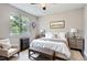 This bedroom has a bench, a window, and two end tables at 11029 Grouse Ct, Parker, CO 80134