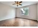 Spacious bedroom featuring a ceiling fan, hardwood floors, and natural light from a large window at 11029 Grouse Ct, Parker, CO 80134