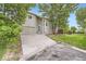Inviting home with a two-car garage, long driveway, and mature shade trees at 11029 Grouse Ct, Parker, CO 80134