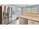Bright kitchen featuring stainless steel appliances, white cabinetry, and tile flooring at 11029 Grouse Ct, Parker, CO 80134