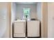 Laundry room featuring a modern washer and dryer next to a bright window at 11029 Grouse Ct, Parker, CO 80134
