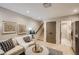 Inviting living area with a comfortable sofa, stylish decor, and easy access to the staircase and other rooms at 2323 S High St, Denver, CO 80210