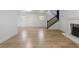 Finished basement with wood-look floors, staircase, and a fireplace for a cozy ambiance at 18396 E Mexico Pl, Aurora, CO 80017