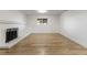 Spacious basement area with light wood flooring, a fireplace, and a window bringing in natural light at 18396 E Mexico Pl, Aurora, CO 80017