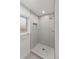 Modern bathroom featuring a tiled shower with a rainfall showerhead and sleek fixtures at 18396 E Mexico Pl, Aurora, CO 80017