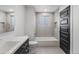 Modern bathroom featuring a stylish vanity, elegant mirror, bathtub, and designer fixtures at 18396 E Mexico Pl, Aurora, CO 80017