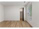 Bedroom showcasing wood-look floors, a window, and closet for convenient storage at 18396 E Mexico Pl, Aurora, CO 80017