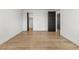 Bedroom featuring wood-look flooring, with closet and doors in sleek black at 18396 E Mexico Pl, Aurora, CO 80017