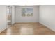 Bedroom with wood-look floors and a window, leading to a tiled bathroom at 18396 E Mexico Pl, Aurora, CO 80017