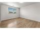 Bright bedroom featuring wood-look floors and a window for ample natural light at 18396 E Mexico Pl, Aurora, CO 80017