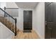 Inviting entryway with hardwood floors, black staircase, black door, and white walls create a warm atmosphere at 18396 E Mexico Pl, Aurora, CO 80017