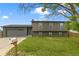 Charming two-story home with a well-maintained lawn and attached garage with a gray exterior elevation at 18396 E Mexico Pl, Aurora, CO 80017