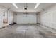 An empty garage stands ready for your vehicle or workshop, with an automatic door and ample lighting at 18396 E Mexico Pl, Aurora, CO 80017