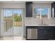 Modern kitchen with stainless steel appliances, sleek countertops, and access to the outdoor patio at 18396 E Mexico Pl, Aurora, CO 80017