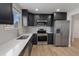 Modern kitchen featuring stainless steel appliances, quartz countertops, and wood flooring at 18396 E Mexico Pl, Aurora, CO 80017