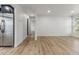 Spacious living room with a large window and sleek wood flooring creating a comfortable and inviting space at 18396 E Mexico Pl, Aurora, CO 80017