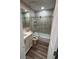 Tiled bathroom featuring a modern glass shower door, white vanity, and stylish fixtures providing a clean and updated look at 10010 Columbine Ct, Thornton, CO 80229