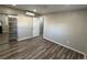 Modern bedroom featuring wood-style floors, a sliding-door closet, and efficient air conditioning, offering comfort and style at 10010 Columbine Ct, Thornton, CO 80229