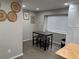 Cozy dining area featuring modern table with chairs and ample cabinet space, illuminated by natural light, perfect for meals at 10010 Columbine Ct, Thornton, CO 80229