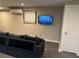 Living room with large gray sofa and mounted television at 10010 Columbine Ct, Thornton, CO 80229