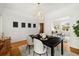 Dining area with hardwood floors, modern lighting and a glimpse into the living room at 1748 W 36Th Ave, Denver, CO 80211