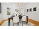 Dining room with hardwood floors, white walls, and a large window at 1748 W 36Th Ave, Denver, CO 80211
