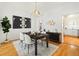 Beautiful dining room with modern chandelier, stylish decor, and hardwood floors at 1748 W 36Th Ave, Denver, CO 80211