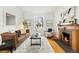 Comfortable living room with a fireplace, large window, and modern furnishings at 1748 W 36Th Ave, Denver, CO 80211