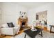 Inviting living room featuring a cozy fireplace, hardwood floors, and stylish decor at 1748 W 36Th Ave, Denver, CO 80211