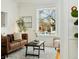 Bright living room with large window, hardwood floors, and comfortable seating arrangement at 1748 W 36Th Ave, Denver, CO 80211