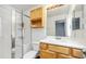 Bathroom featuring glass enclosed shower, ample lighting, and vanity with storage at 9484 E 108Th Ave, Commerce City, CO 80640