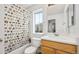 Bright bathroom featuring a tub with a fun shower curtain and vanity at 9484 E 108Th Ave, Commerce City, CO 80640