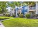 Beautiful blue townhome featuring a well-manicured lawn and private balconies at 9484 E 108Th Ave, Commerce City, CO 80640
