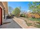 Backyard with a hot tub, concrete patio, lush greenery and wooden fence, creating a relaxing outdoor space at 1155 S Balsam St, Lakewood, CO 80232