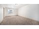 An empty room with carpet flooring and a basement window for a buyer to imagine the endless possibilities at 1155 S Balsam St, Lakewood, CO 80232