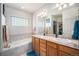 Bright bathroom featuring a soaking tub, a double sink vanity, and tile flooring at 1155 S Balsam St, Lakewood, CO 80232