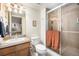 Functional bathroom featuring a shower with glass doors, modern fixtures, and a sink at 1155 S Balsam St, Lakewood, CO 80232