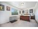 Bright bedroom with neutral walls, a window with shade, wood furnishings, and a cage at 1155 S Balsam St, Lakewood, CO 80232