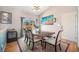 Bright dining room featuring a rustic table, elegant lighting, and a sliding glass door at 1155 S Balsam St, Lakewood, CO 80232