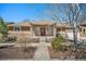 Charming single-story home featuring stone accents, a cozy front porch, and a well-maintained landscape at 1155 S Balsam St, Lakewood, CO 80232