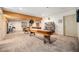 Spacious game room featuring a shuffleboard table, shelving, and a doorway at 1155 S Balsam St, Lakewood, CO 80232