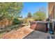 Backyard hot tub surrounded by landscaping and a wooden fence, providing a private oasis at 1155 S Balsam St, Lakewood, CO 80232