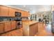Well-appointed kitchen featuring granite countertops, stainless steel appliances, and an eat-in island at 1155 S Balsam St, Lakewood, CO 80232