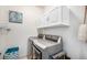 Well-equipped laundry room with modern washer, dryer and storage cabinets at 1155 S Balsam St, Lakewood, CO 80232