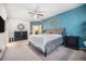 Comfortable main bedroom featuring a blue accent wall, neutral decor, and ceiling fan at 1155 S Balsam St, Lakewood, CO 80232