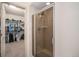 Spacious walk-in closet with ample storage and shelving adjacent to a shower with glass door at 1155 S Balsam St, Lakewood, CO 80232