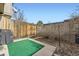 Outdoor patio area with green turf and partial fencing, a backyard grill, and space for relaxing at 8862 E Amherst Dr # D, Denver, CO 80231