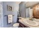 Bathroom with a sink, mirror, wall-to-wall carpet and a decorative vase of greenery at 8862 E Amherst Dr # D, Denver, CO 80231