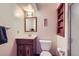 Clean and well-lit bathroom featuring a mirrored vanity, toilet, and shower at 8862 E Amherst Dr # D, Denver, CO 80231