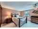 Bedroom featuring a bed, bedside tables, a window, wall-to-wall carpeting and a ceiling fan at 8862 E Amherst Dr # D, Denver, CO 80231